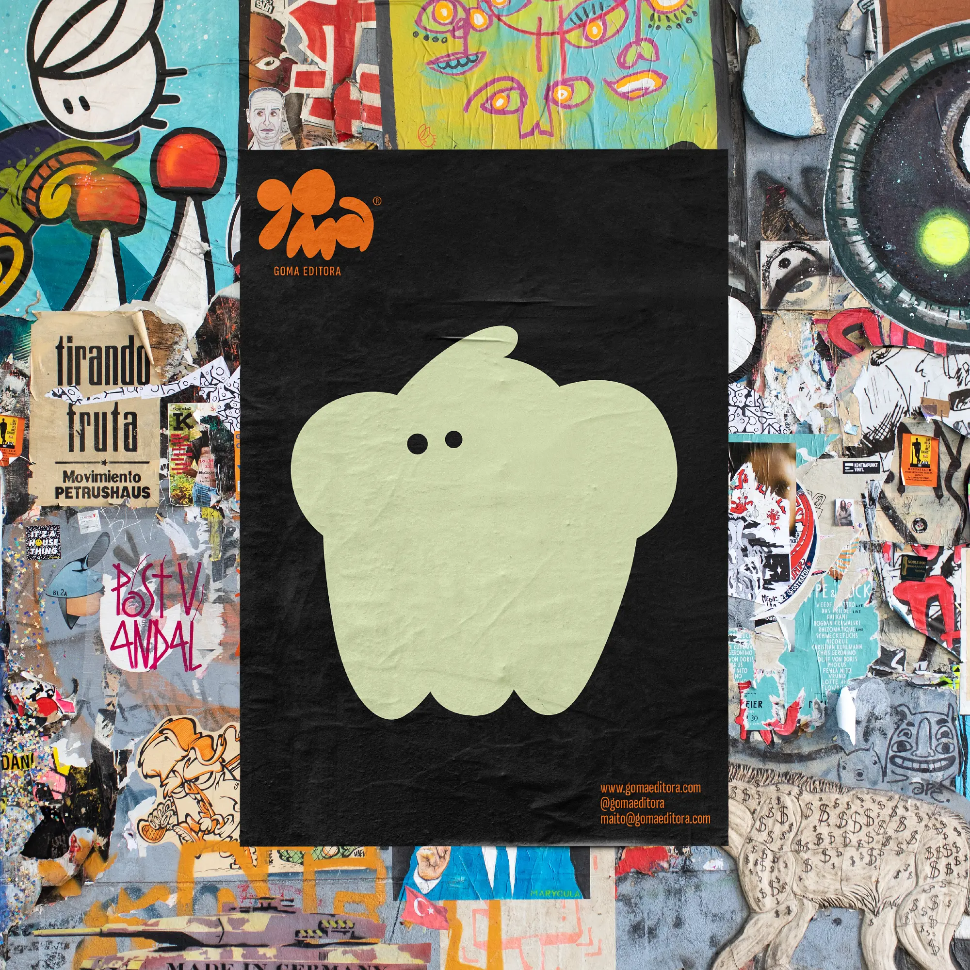 Black Goma poster with a pale green abstract character on a collage wall.