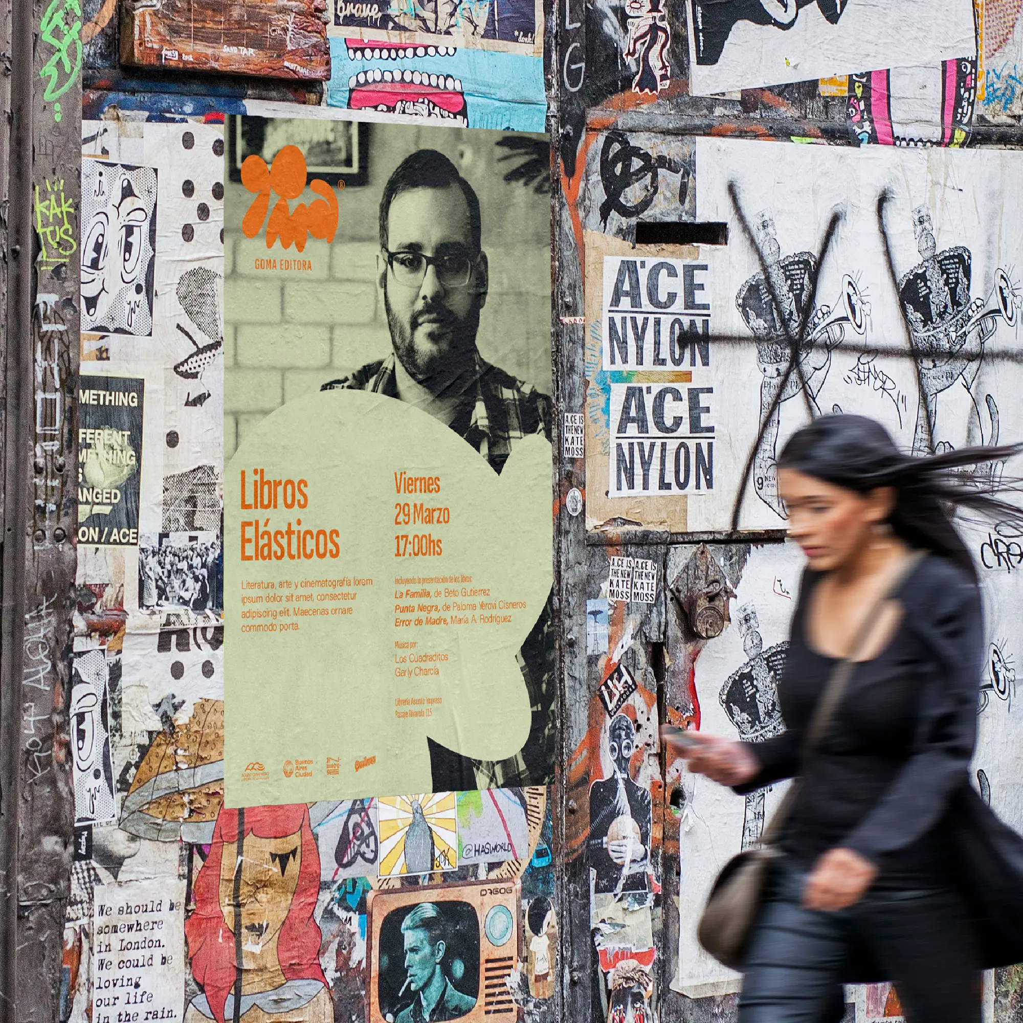 Goma event poster on a layered city poster wall.