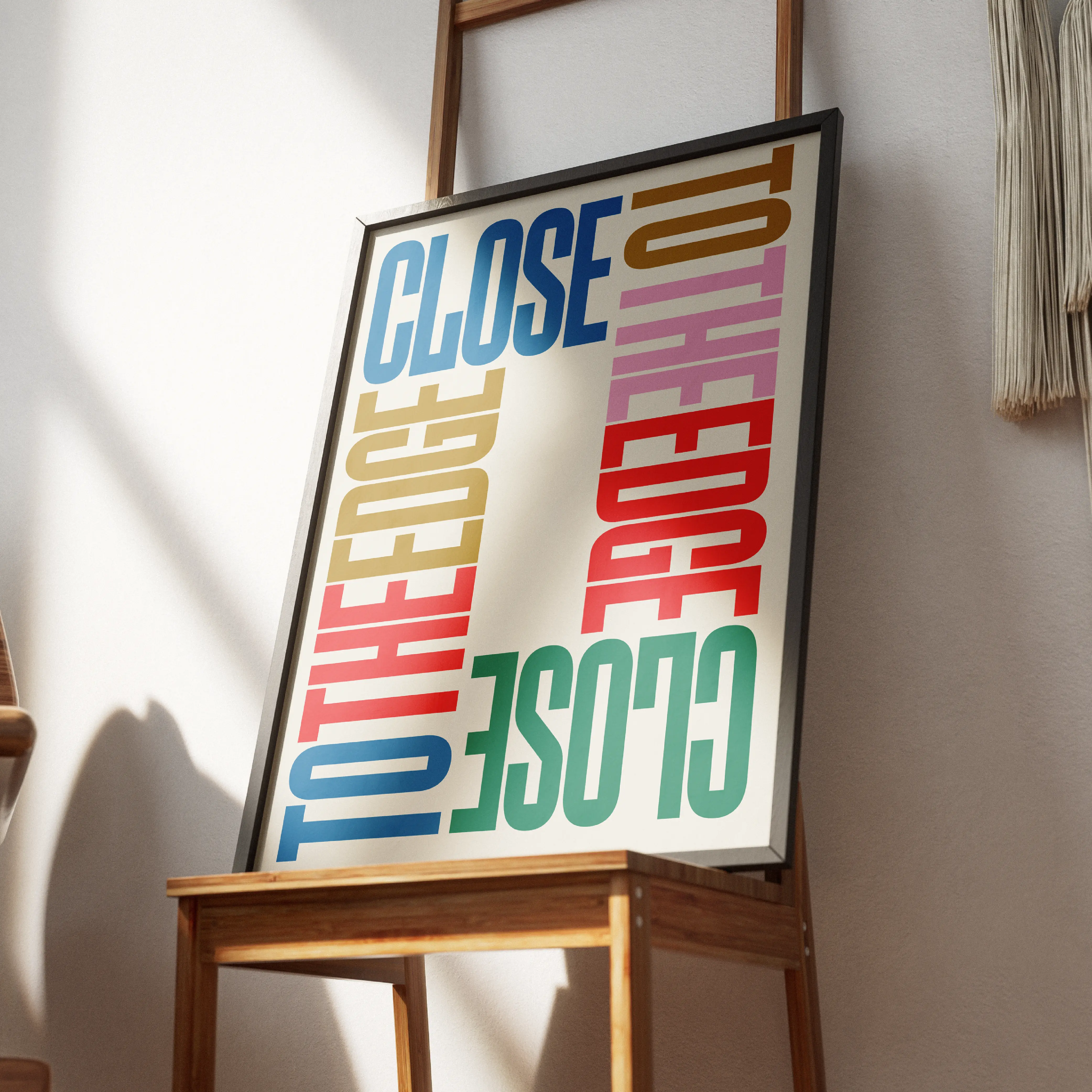 Framed Brinca poster with repeated Close text in colorful type.