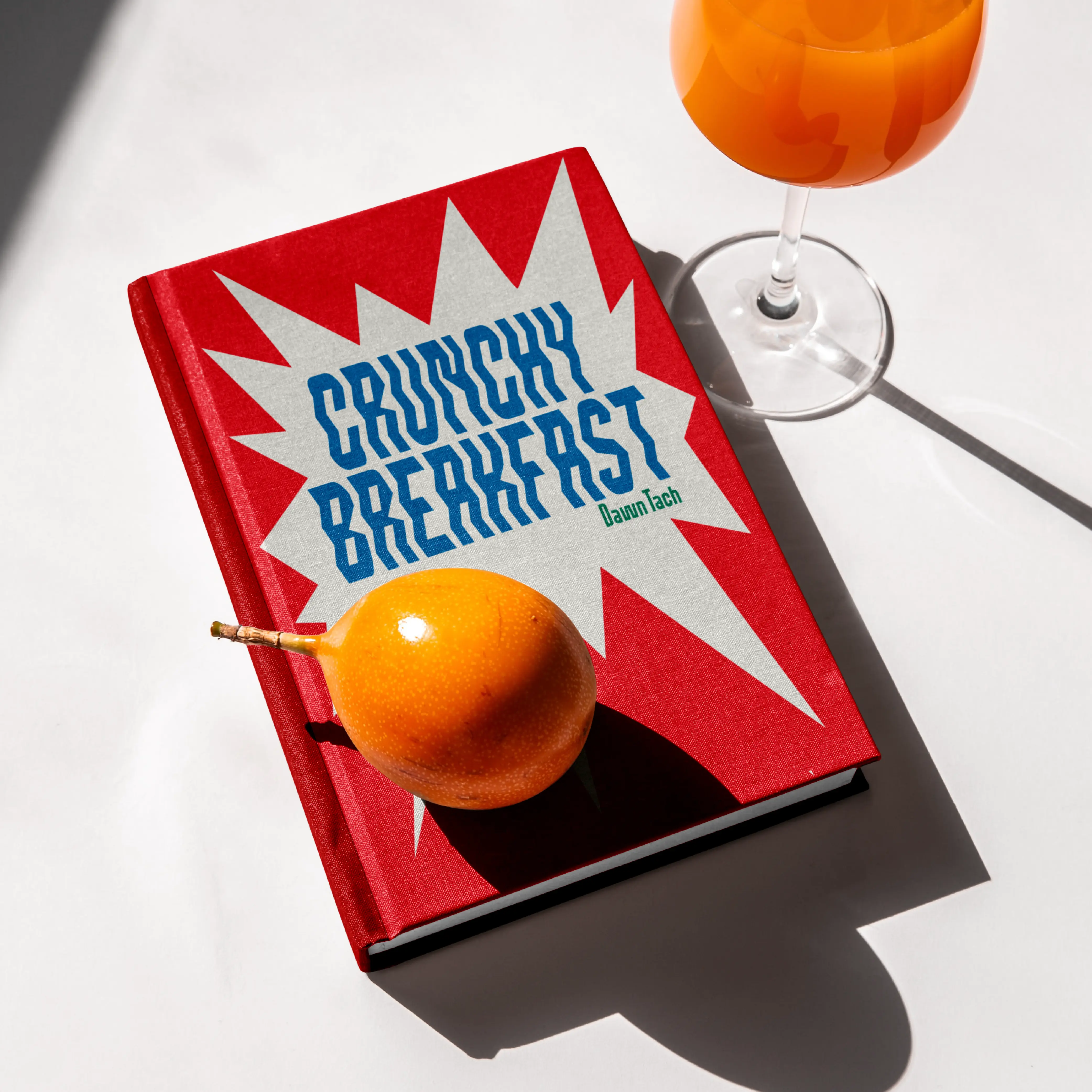 Brinca breakfast booklet on a table with oranges and a drink.